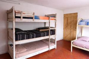 two bunk beds in a room with a door at La mansion caballero hostal in Asunción