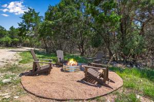 two benches sitting around a fire in a park at Terlingua at the Bend in Wimberley