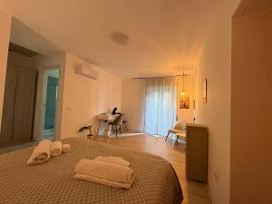 a bedroom with a bed with two towels on it at Kalon Brion House in Lamezia Terme