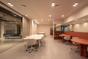an office with desks and chairs and tables at Codomo Living Granada in Granada +60 photos