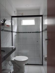 a bathroom with a shower with a toilet and a sink at Acomodações em Bananeiras, PB in Bananeiras +8 photos