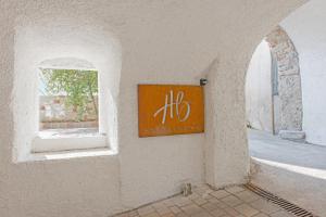 a sign on the side of a building with a window at HB Boutique Apartment in Arco