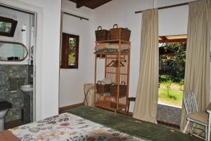 a bedroom with a bed and a room with a window at La Casetta di Saha in collina in Itri