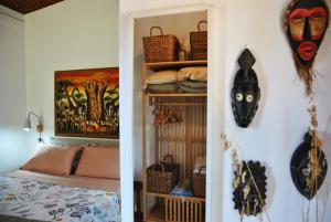 a bedroom with a bed and some items on the wall at La Casetta di Saha in collina in Itri +17 photos