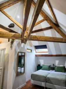 a room with white walls and wooden beams at Maison Maubert in Thiers