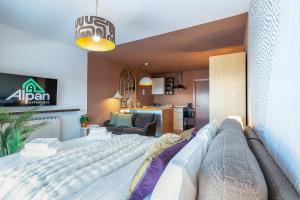 a bedroom with a large bed and a living room at ALPHIRA - Vista Montagne e Deposito per Sci e Bici in Pila