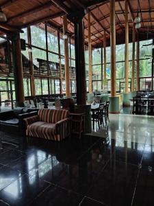a lobby with a couch and tables and chairs at Hotel Don Horacio in Puerto Iguazú