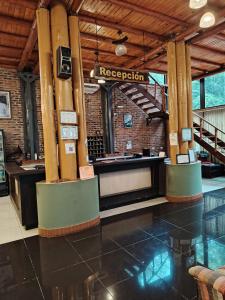 a lobby with a reception desk in a building at Hotel Don Horacio in Puerto Iguazú +85 photos