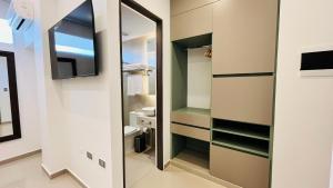 a small bathroom with a mirror and a toilet at Hotel Murahno Collection in Cúcuta +66 photos