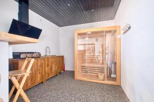 a kitchen with a counter and a glass door at BELLEVUE 2, piscine, jacuzzi, sauna in Champcevinel