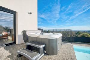 a bathroom with a sink and a swimming pool at BELLEVUE 2, piscine, jacuzzi, sauna in Champcevinel