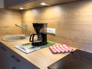 a kitchen counter with a blender on a counter top at Landhaus Waldhauser in Schönau am Königssee +158 photos