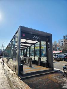 a bus stop on the side of a street at Mignon Stay FreeParking Near KSPODome AsanMedicalCenter LotteWorldTower in Samgong