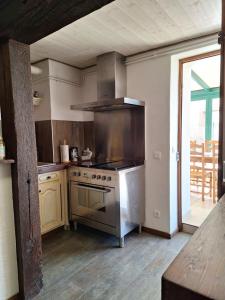 a kitchen with a stainless steel stove top oven at Chambre d'hôte au Grenier d'Abondance in Niderviller