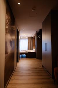 a hallway leading to a bedroom with a bed at LH Linzerhaus Suites Saalbach - inklusive Jokercard in Saalbach-Hinterglemm