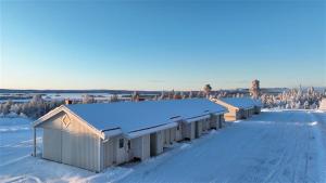a row of buildings with snow on the roof at Simloc Hotel Öberget in Arjeplog