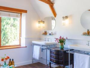 a bathroom with two sinks and a window at Navarre Residence in Stellenbosch +14 photos