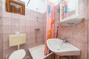 a bathroom with a toilet and a sink at Apartments Palmero in Gradac +48 photos