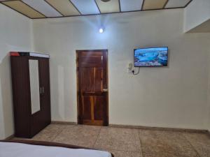 a room with a door and a picture on the wall at Naturehouse in Jaffna