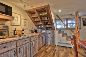 a kitchen with wooden cabinets and a staircase in a house at Sunflower Ridge Cabin in San Marcos