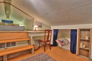 a room with a bed and a desk and a chair at Sunflower Ridge Cabin in San Marcos