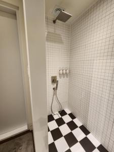 a bathroom with a black and white checkered floor at 바티하우스 in Ara-ri +43 photos