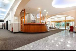 an empty lobby with a counter in a building at Teplice Plaza in Teplice