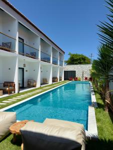 an image of a swimming pool next to a building at Yahweh Hotel in São Miguel do Gostoso
