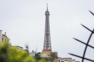 a view of the eiffel tower in the city at Hôtel La Bourdonnais by Inwood Hotels in Paris