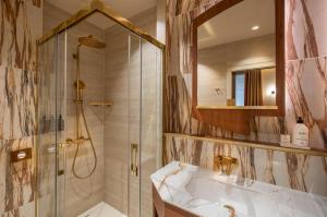 a bathroom with a tub and a shower and a sink at Hôtel La Bourdonnais by Inwood Hotels in Paris