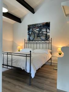 a bedroom with a bed with a bike on the wall at The Exclusive 6 bedroom Farm House, Markington incl heated pool and The Richmond Hill one bedroom Cottage in Ingerthorpe +104 photos