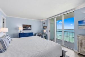 a bedroom with a bed and a view of the ocean at Tristan Towers Unit 10E in Pensacola Beach