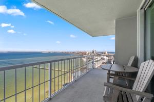 a balcony with a table and chairs and the ocean at Tristan Towers Unit 10E in Pensacola Beach