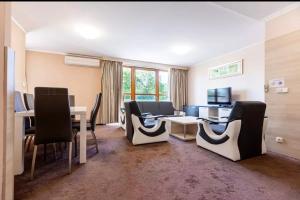 a room with a table and chairs and a dining room at Teplice Plaza in Teplice