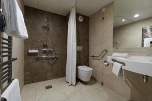 a bathroom with a shower and a toilet and a sink at Appart One Aix-les-Bains in Aix-les-Bains