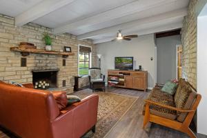 a living room with a couch and a fireplace at Stone River Cabin in Canyon Lake