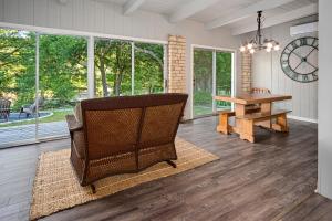 a living room with a chair and a table at Stone River Cabin in Canyon Lake
