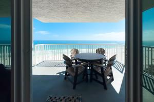 a table and chairs on a balcony with the ocean at Romar Tower Unit 9D in Orange Beach
