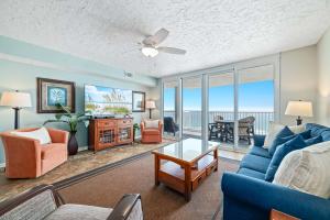 a living room with a couch and chairs and a table at Romar Tower Unit 9D in Orange Beach +44 photos