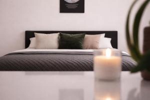 a bedroom with a bed with a candle on a table at Stadthotel Carinthia in Klagenfurt
