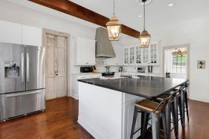 a kitchen with white cabinets and a black counter top at Stone Ridge Retreat in Canyon Lake