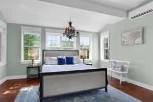 a bedroom with a bed with blue pillows and a chandelier at Stone Ridge Retreat in Canyon Lake
