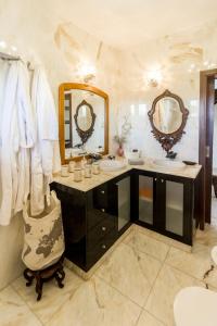 a bathroom with two sinks and two mirrors at Guest H4U Villa Garden & Pool in Póvoa de Varzim +77 photos