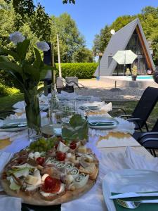 a table with a plate of food on it at Vikendica Sofijina Luka in Slatina Varoš