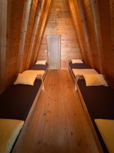 a room with three beds in a wooden cabin at Vikendica Sofijina Luka in Slatina Varoš +32 photos
