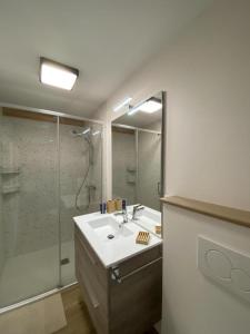 a bathroom with a sink and a shower at Petit péric in Puyvalador +9 photos