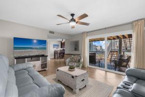 a living room with a view of the beach at Boardwalk Unit A18 in Pensacola Beach +53 photos