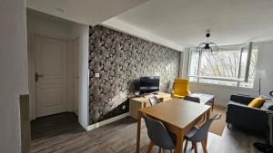 a living room with a table and a couch at T3 idéalement situé in Mérignac