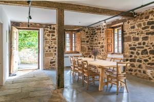 a dining room with a wooden table and chairs at La Villa de Carla in Borleña +36 photos