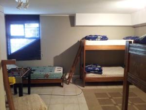 a room with two bunk beds and a table at Departamento Playa Amarilla Con Con in Concón